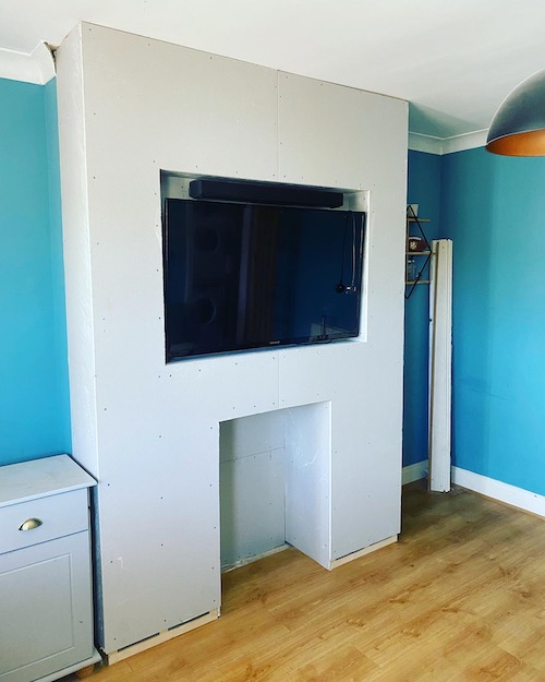 media unit built around wall mounted TV