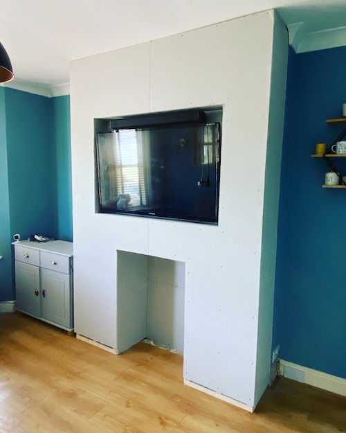 media unit built around wall mounted TV