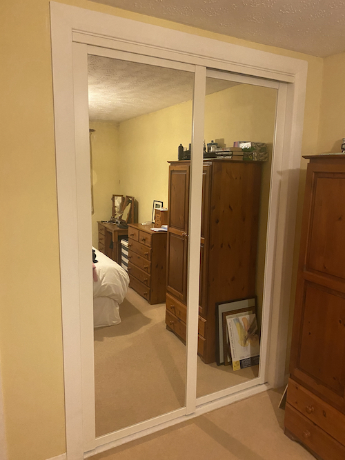 sliding mirror installed in bedroom