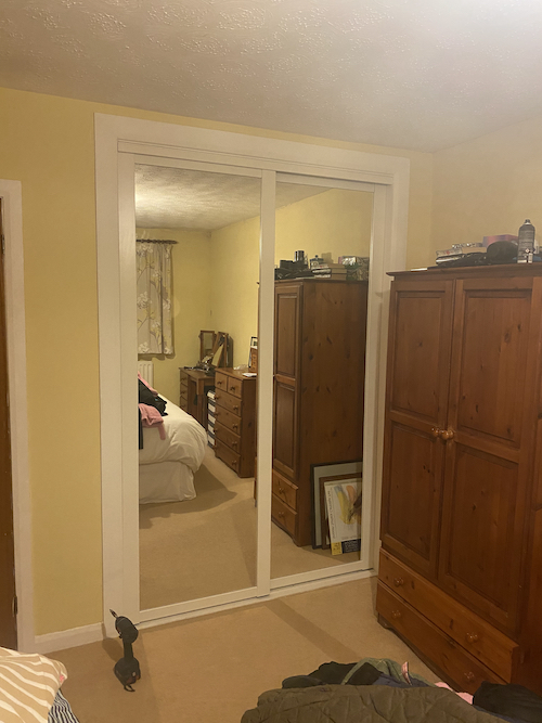 sliding mirror installed in bedroom